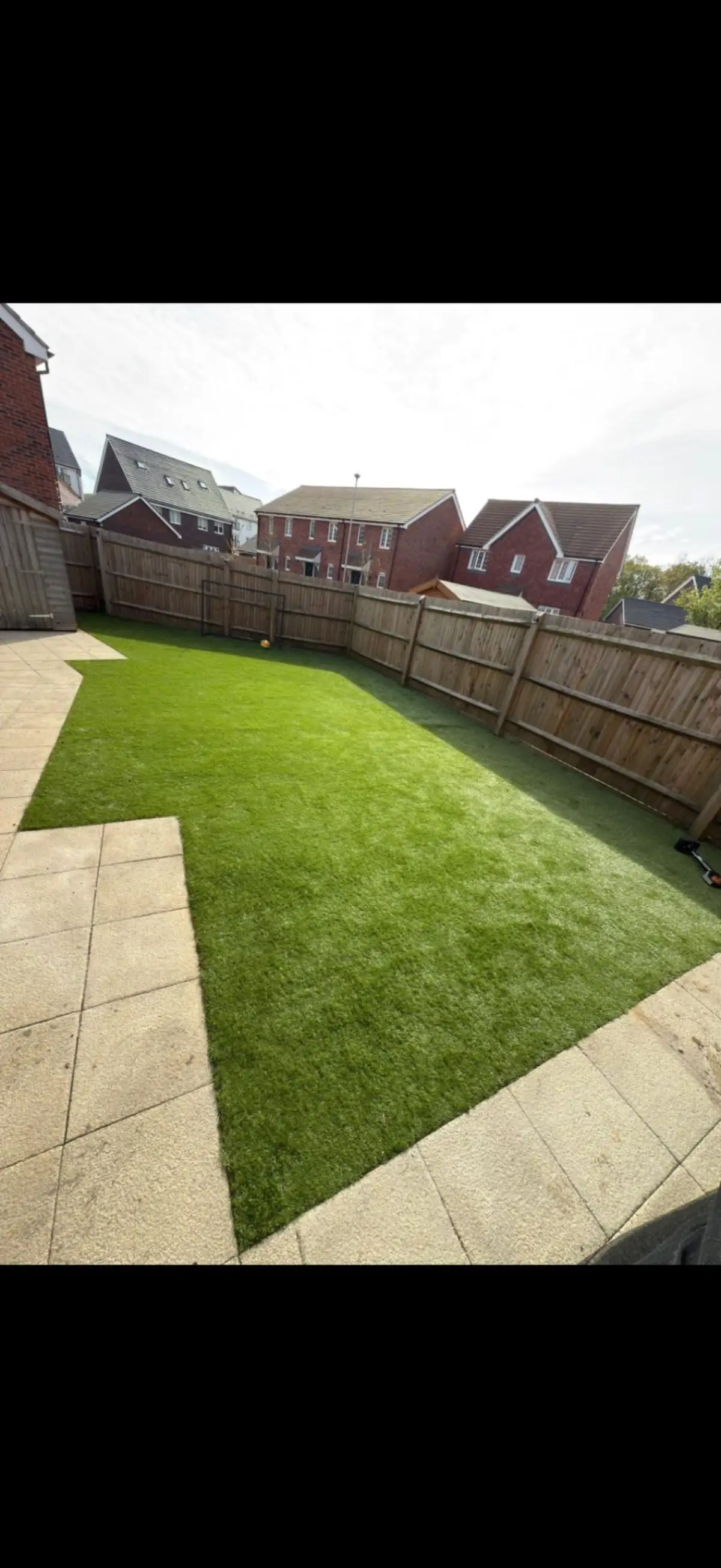 Artificial lawn with paving border installation by Burton Builds landscaping