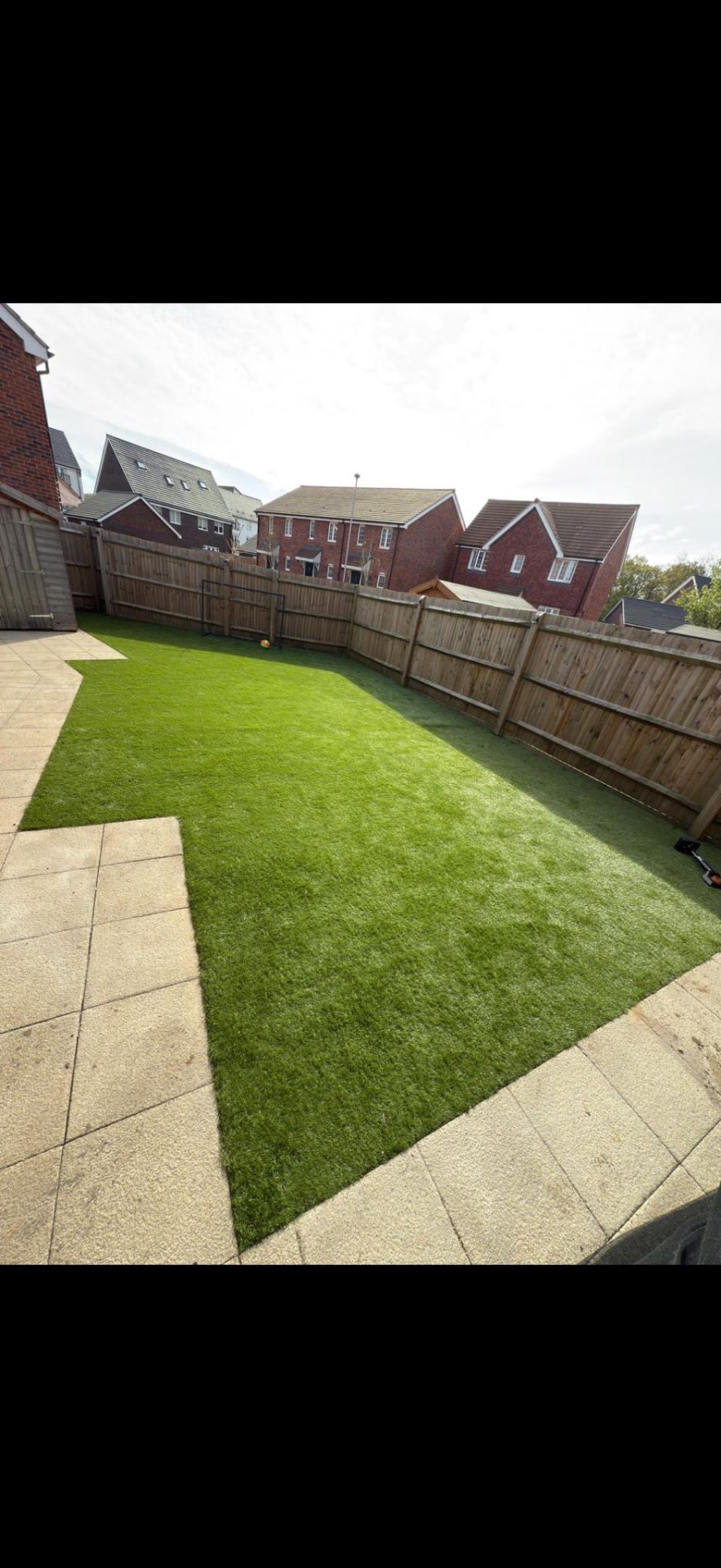 Artificial lawn with paving border installation by Burton Builds landscaping