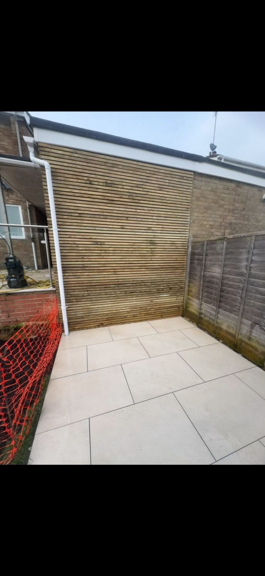 Paving with timber slat privacy screen by Burton Builds
