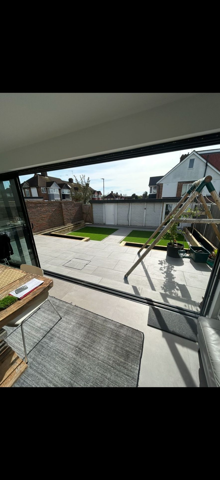 Home extension interior looking out to landscaped garden by Burton Builds