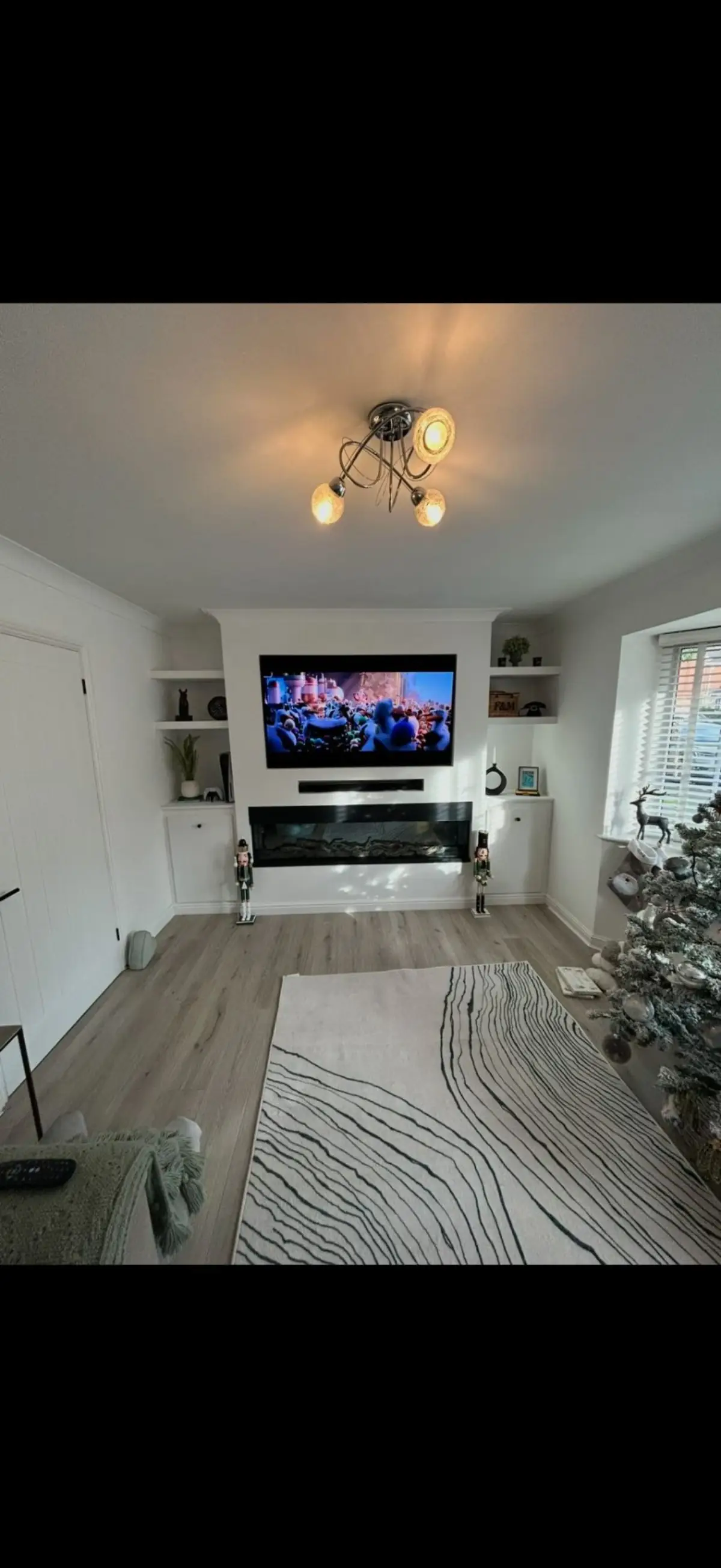 Custom media wall with TV mount and electric fireplace by Burton Builds