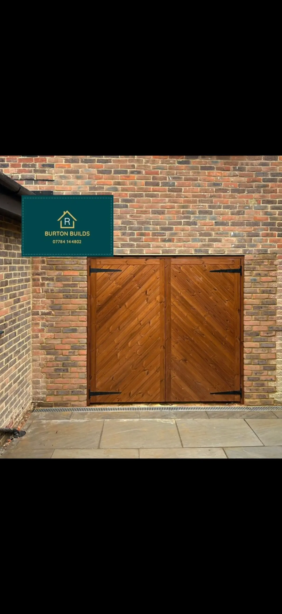 Bespoke wooden garage doors with brick surround and paving by Burton Builds carpentry team