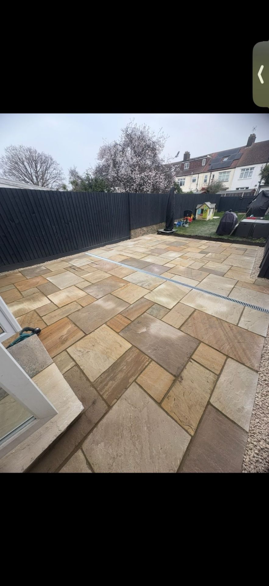 Indian sandstone paving in rear garden by Burton Builds