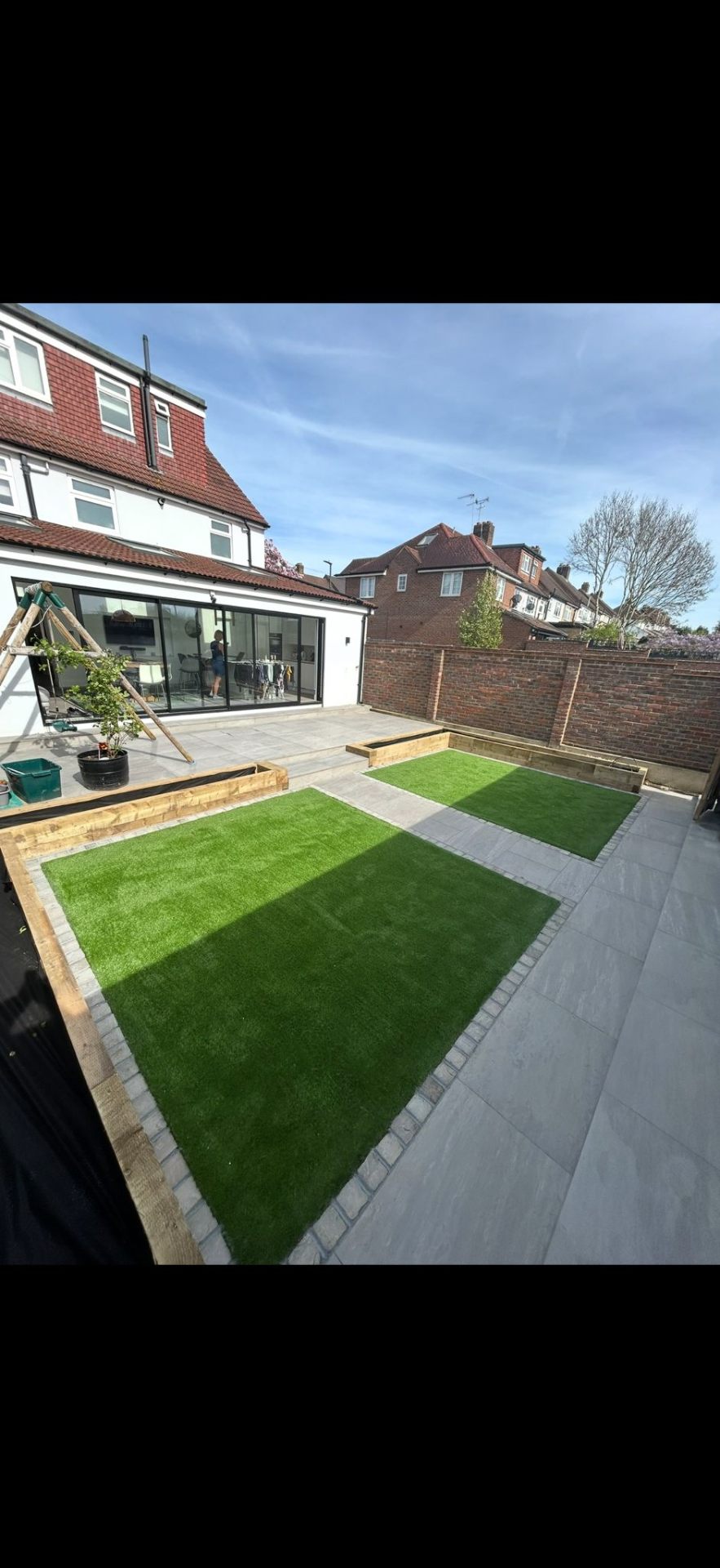 New turf lawn installation with paving border by Burton Builds